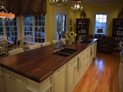 Custom Walnut wood island countertop with 2 undermount farm sinks. This wide plank walnut countertop has a large cove and bead edge profile. Dimension are 1.75” thick x 50” x 188”. Expanded corners on both ends of top. Permanent finish. Installed just outside of Charlotte in Weddington , NC.